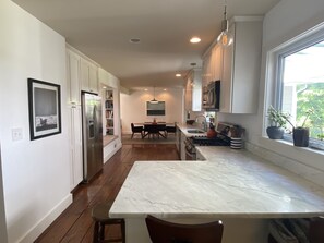 Enjoy cooking in this well-equipped kitchen with a central island, sink, and stove.