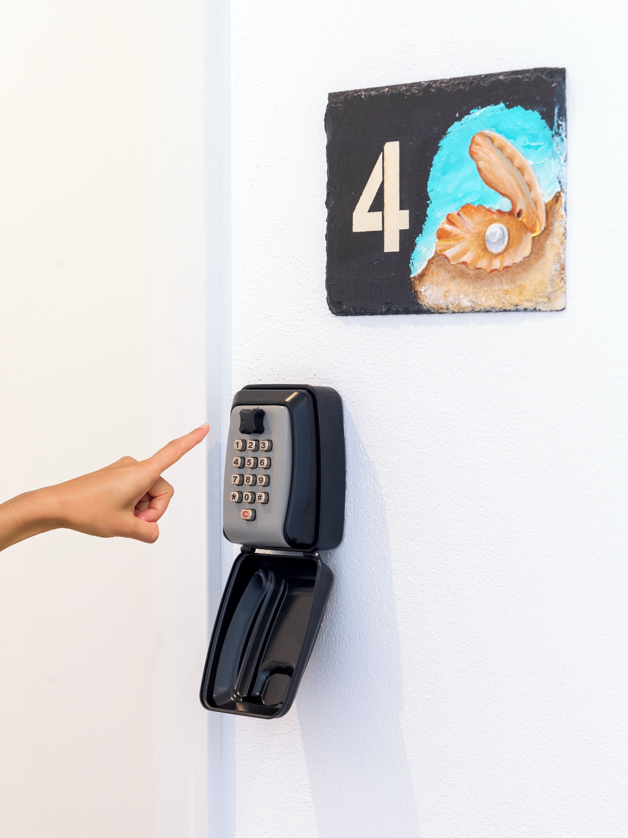 A door with a number plate and a keypad lock.