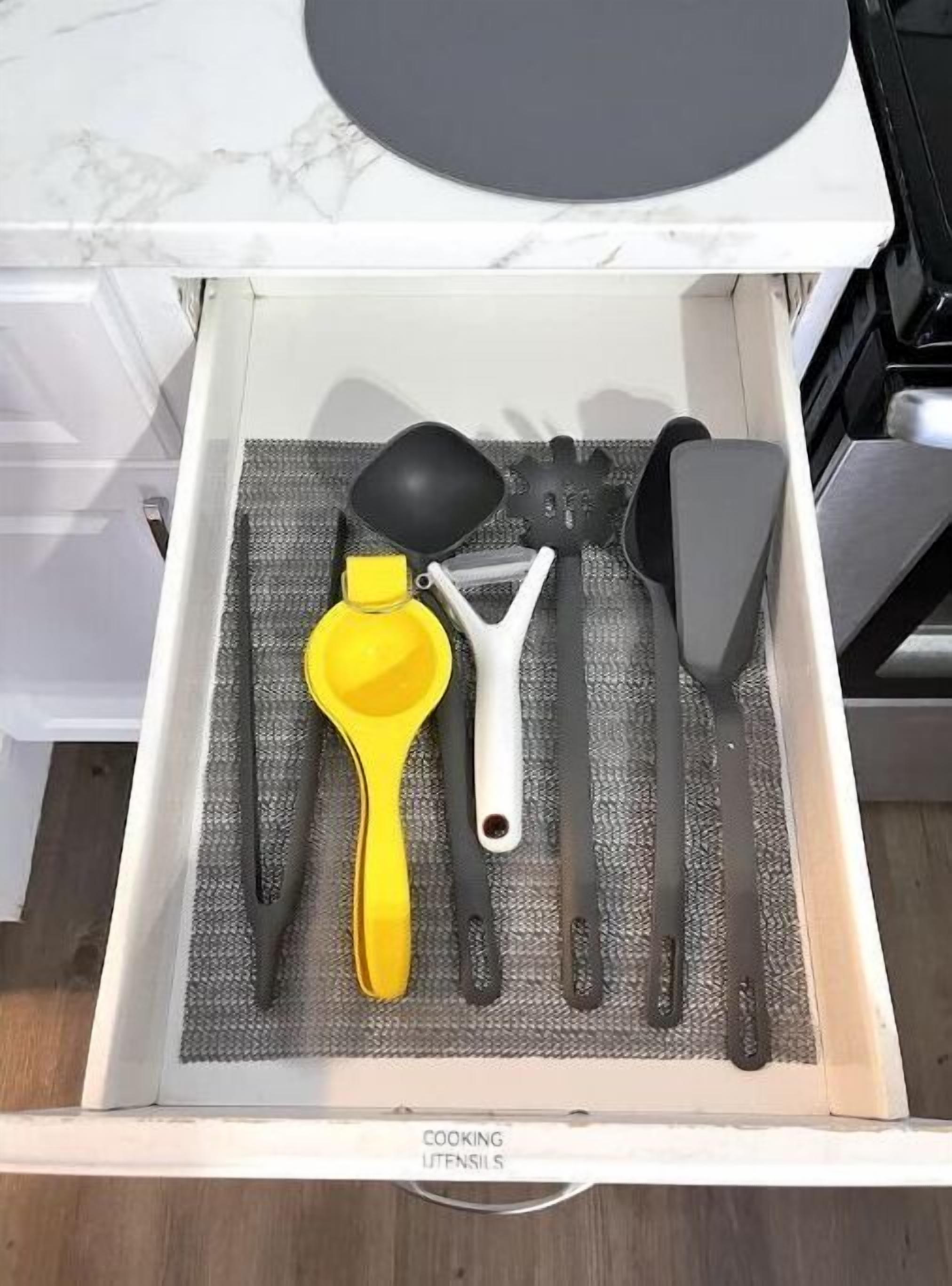 A drawer containing various cooking utensils.