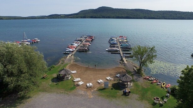 A marina with boats docked, a gazebo, and a grassy area with lounge chairs. - 2 Bedroom Railroad layout (Cooperstown)