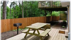 A wooden deck with picnic tables and a mailbox. - 2 Bedroom Railroad layout (Cooperstown)