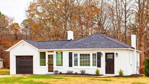 A single-story house with a garage, a front porch, and a chimney. - Salem Road Ranch | 3 BR w/ Outdor Firepit and Backyard (Lincolnton)