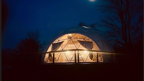 A dome-shaped building at night with a visible interior light source. - Dome 1 - Luxury Dome at Come Spring Farm (Union)