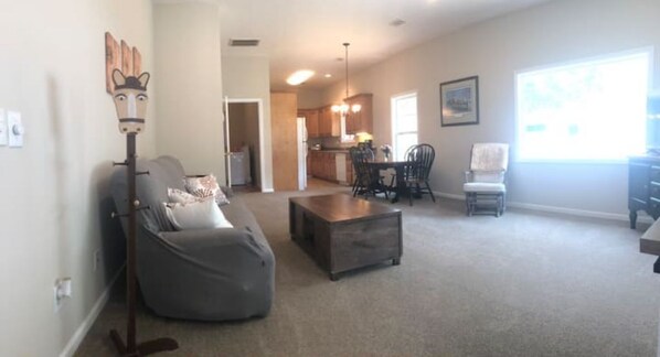 Relax in this inviting living space with a comfortable bean bag chair and dining area.