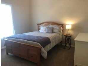 Cozy retreat with a single bed, bedside table, and storage unit.
