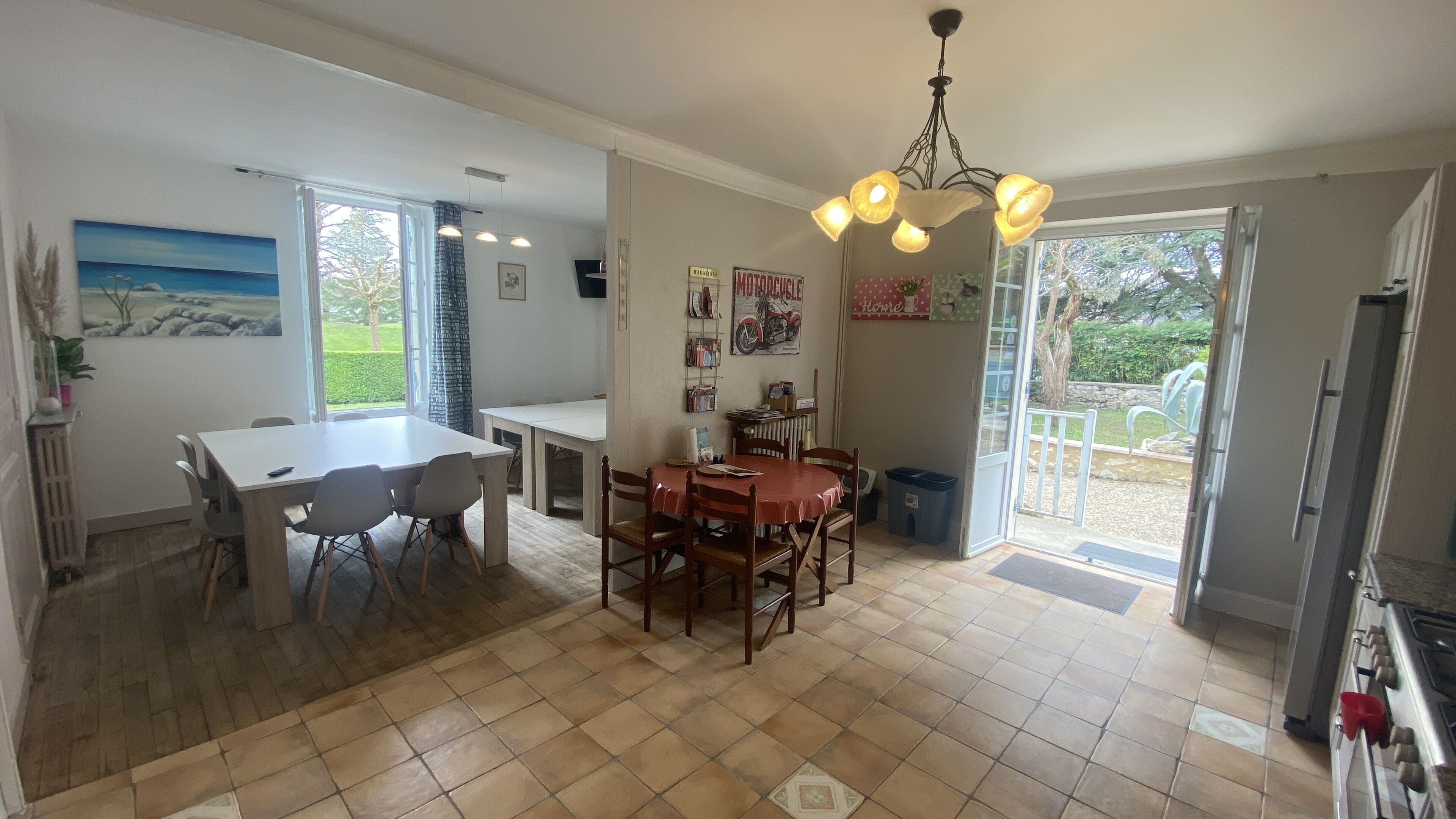 Una cocina amplia con comedor, ventanas grandes y vistas al exterior.