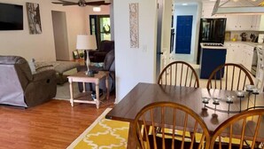 A compact living space with a dining area, kitchenette, and a ceiling fan. - Kerr Contentment   Kerr Lake/Buggs Island waterfront, an amazing view (Clarksville)
