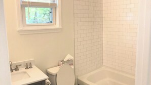 Ein Badezimmer mit Toilette, Waschbecken und Badewanne.