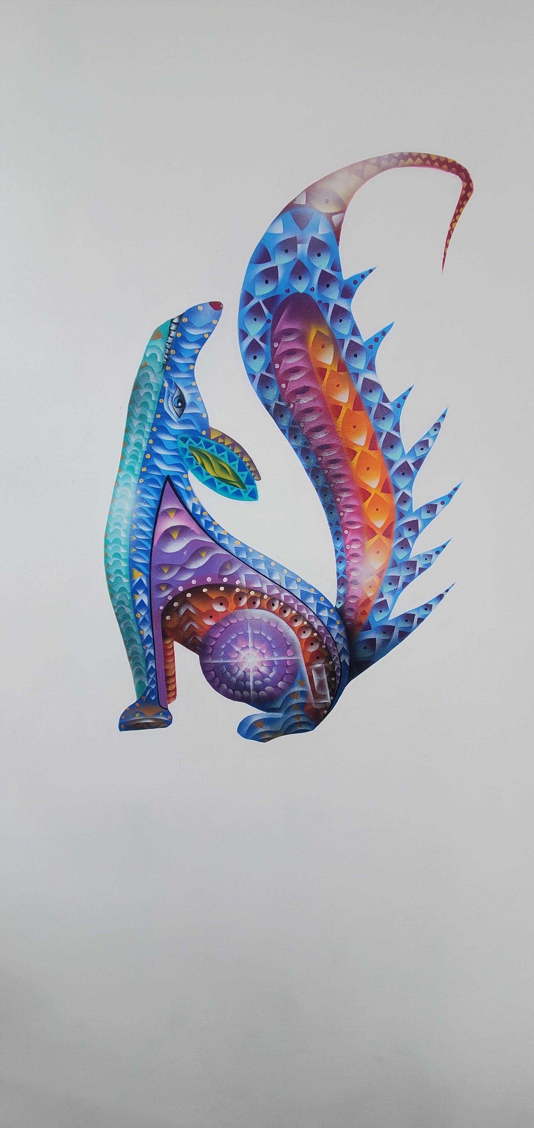 A colorful, abstract sculpture of a dinosaur.