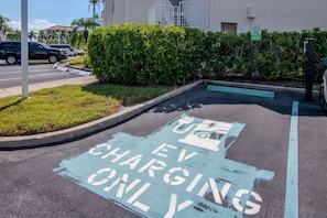 A parking space marked for electric vehicle charging with a sign indicating 'EV CHARGING ONLY'. - Isla Del Sol 1st Floor 2BD/2BA. Close to Beaches (St. Petersburg)