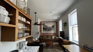 A kitchen with wooden shelves, a coffee maker, and a marble countertop. - Brickhaven Loft on Historic Main Street - walk to Spring River, State Park, more (Mammoth Spring)