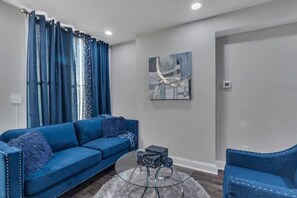 Relax in this stylish living room with a sofa, armchair, and coffee table.