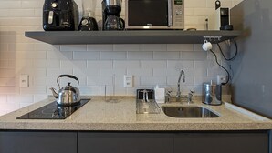 A kitchen with a microwave, kettle, coffee maker, and a sink. - 4 Minutes From Ipanema Beach Fa202 (Rio de Janeiro)