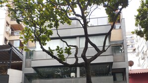 A multi-story building with a modern design, featuring balconies and large windows. - 4 Minutes From Ipanema Beach Fa202 (Rio de Janeiro)
