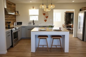 Enjoy meals in the kitchen with a central island and appliances, or dine in the adjacent seating area with a fireplace.