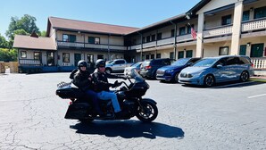 A two-story building with a parking lot. - Alpine Valley Inn (Helen)