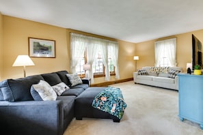 A living room with a sofa, a coffee table, and a blue cabinet.
