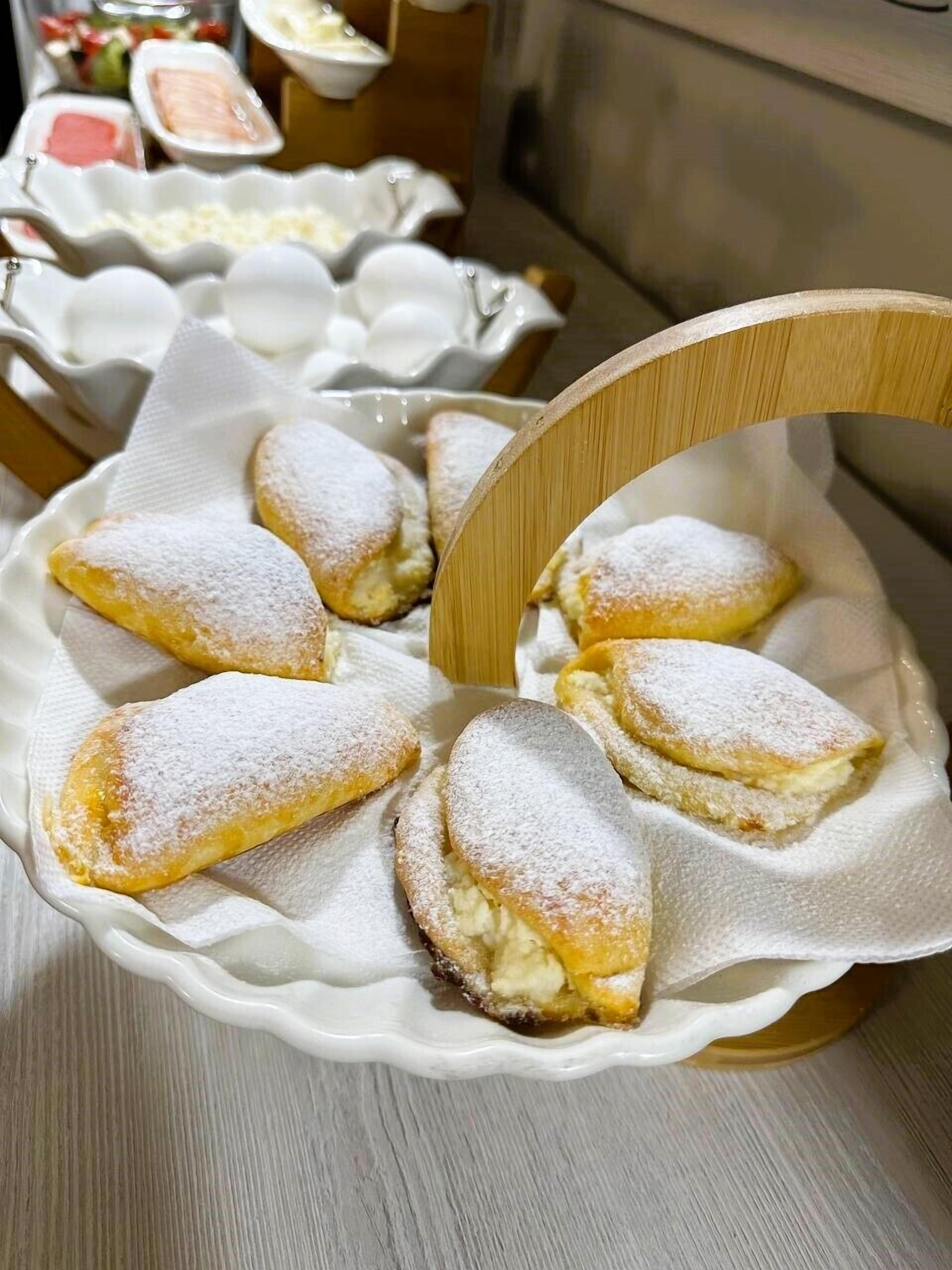 A plate of pastries dusted with powdered sugar.
