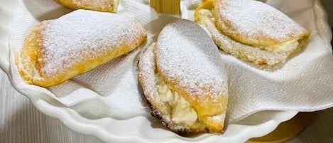 A plate of pastries dusted with powdered sugar.