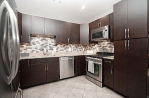 Kitchen equipped with an oven, microwave, and dishwasher.