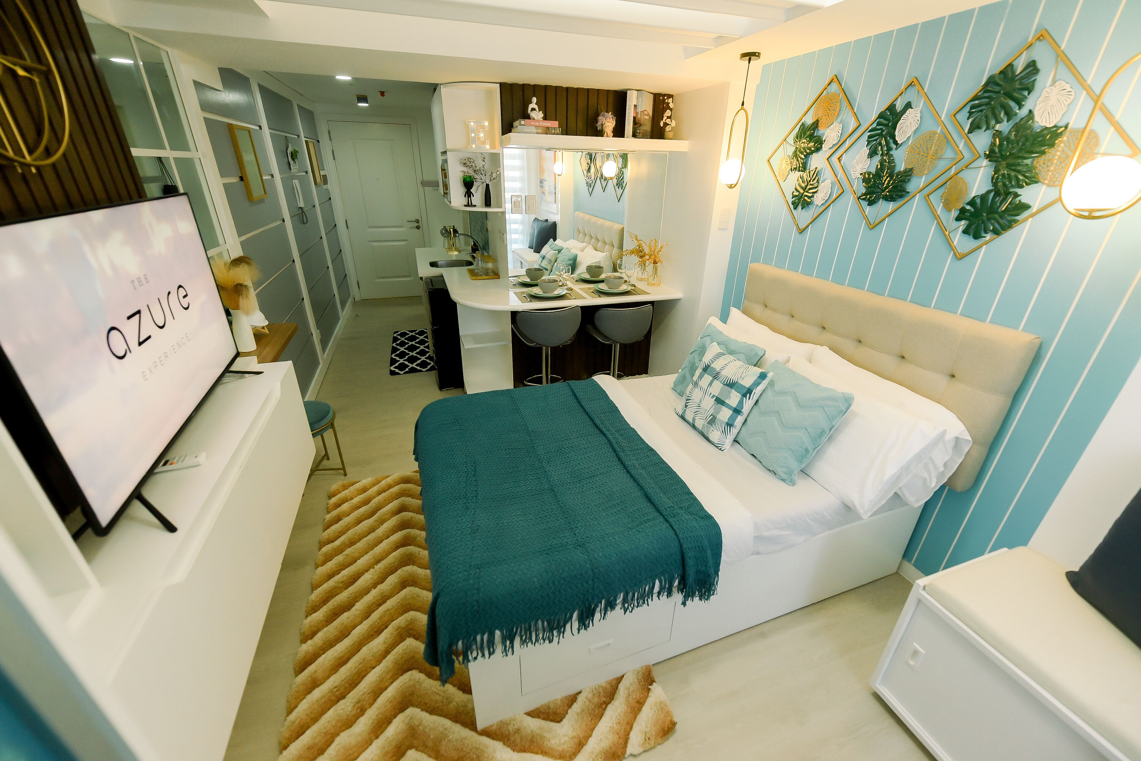 A modern bedroom with a bed, bedside tables, and a TV.