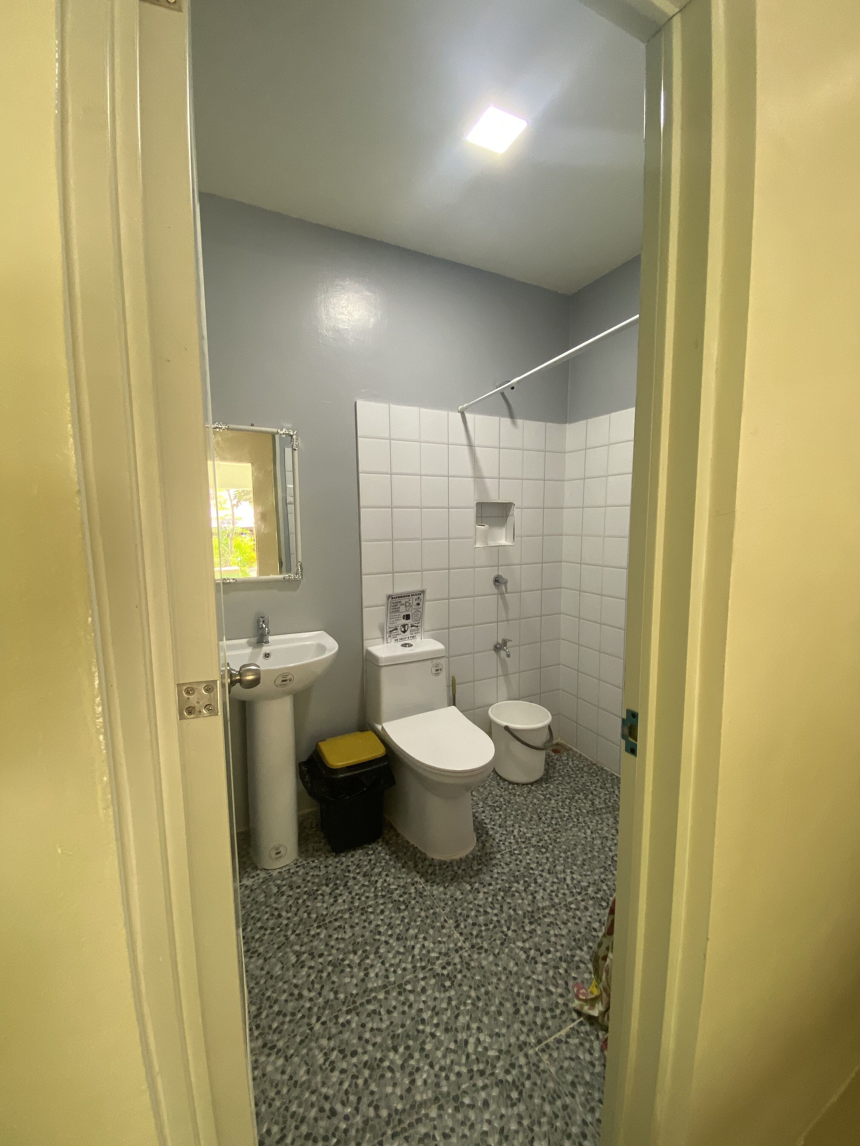 A bathroom with a toilet, sink, and shower.