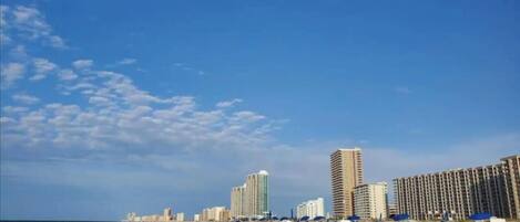 A beach with high-rise buildings in the background.