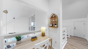 Relax in a serene space with a large mirror, desk, and potted plant.