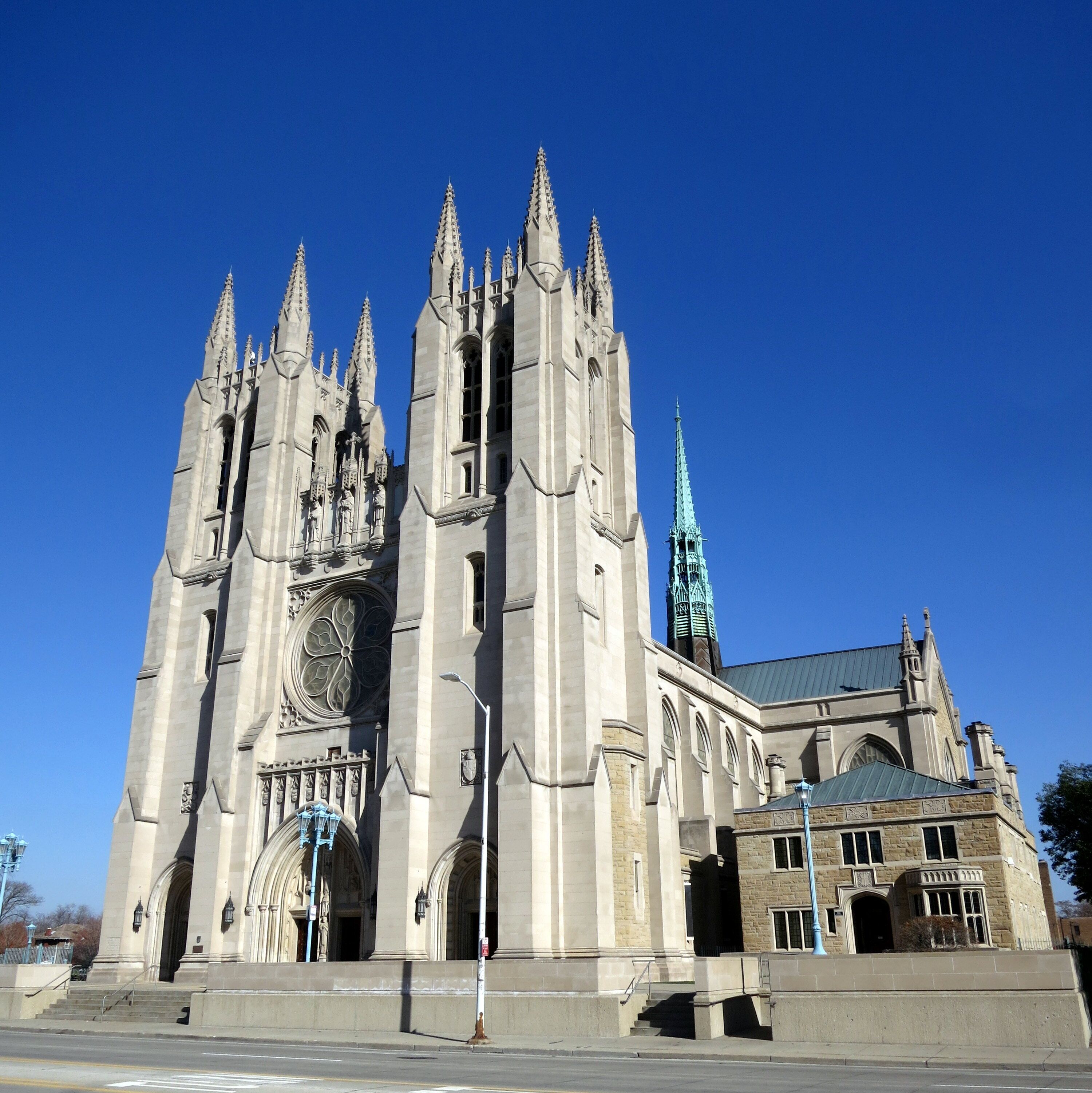 A large, historic cathedral with multiple spires and a prominent clock tower.