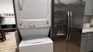 A compact kitchen with a stainless steel refrigerator, a built-in oven, and a microwave. - 2-bedroom vacation home just 6 minutes from SoFi Stadium (Los Angeles)