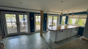 Enjoy cooking in this well-equipped kitchen with a central island and sliding glass door leading to an outdoor deck.