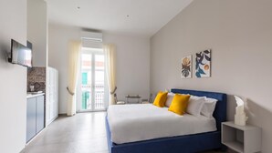 A bedroom with a bed, a TV, a desk, and a window with curtains. - Duomo Charme Studio by Wonderful Italy (Naples)