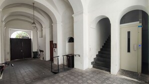 An interior with arched ceilings, a staircase, and a door with a blue sign. - Sorrento Hearts in Sorrento (Sorrento)