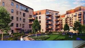 Un immeuble d’appartements moderne, doté de plusieurs étages, de balcons et d’un jardin aménagé.