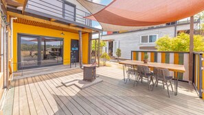 Enjoy dining al fresco on the deck, surrounded by lush greenery and comfortable seating.
