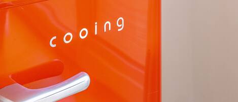A close-up of an orange appliance with the word "cooling" visible.
