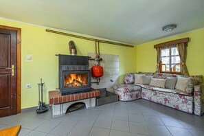 Family House, Multiple Bedrooms, 2 Bathrooms (Kunstek Farmhouse With Sauna) | Living area | 21-inch flat-screen TV with cable channels, TV, fireplace - Kunstek Farmhouse With Sauna (Rogatec)