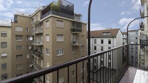 A multi-story residential building with balconies, satellite dishes, and a clear sky. - Italianway - Mauro Macchi 65 (Milan)