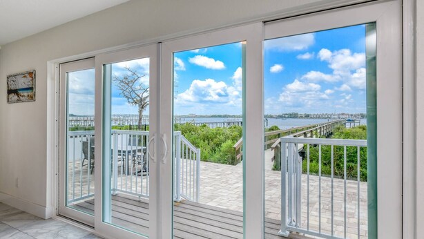A spacious balcony with a view of a waterfront and a bridge. - Dolphin View (St. Augustine)