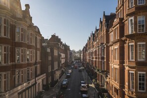 A street lined with historic buildings, a clear sky, and parked cars. - The Connaught Suite in London (London)