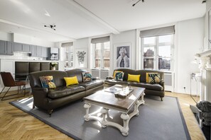 A modern living room with two sofas, a coffee table, and a dining area. - The Connaught Suite in London (London)