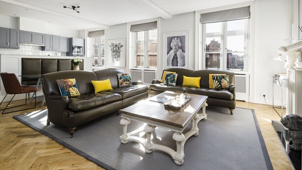 A modern living room with two sofas, a coffee table, and a dining area. - The Connaught Suite in London (London)