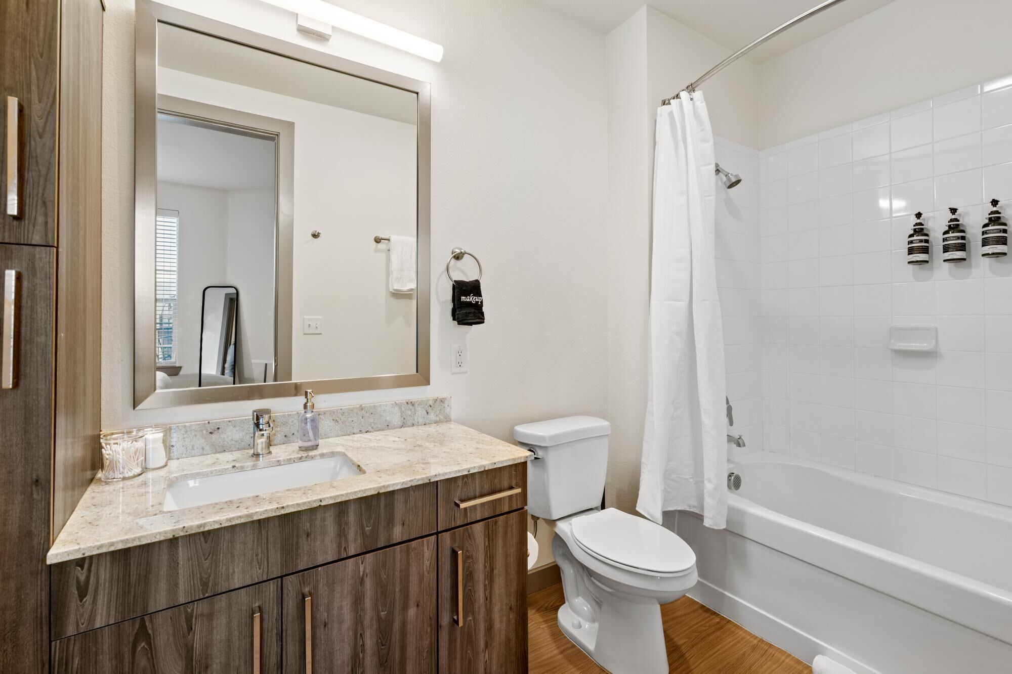 A modern bathroom with a sink, toilet, and bathtub.