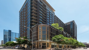 A multi-story hotel with a prominent entrance, large windows, and a modern architectural design. - Austin Beautiful Studio Apartment (Austin)