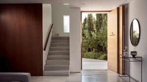 A modern interior with a staircase leading to a conservatory.