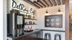 A modern coffee bar with a Starbucks logo, a menu board titled "Know Your Coffee," and two bar stools. - Alexandria Alluring 2BD 2BA Apartment (Alexandria)