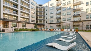 A modern hotel with a large pool area, multiple balconies, and a well-maintained garden. - Arlington Stylish 2BD 2BA Apartment (Arlington)