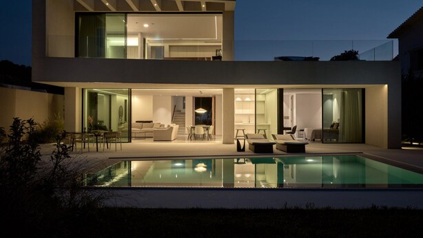 A modern two-story house with a swimming pool, large glass windows, and a well-lit interior. - Butterflies Villas Spa-villa Plumeria (Zakynthos)