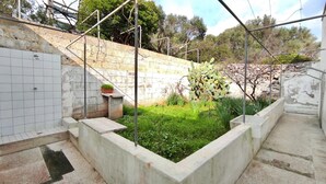 A small outdoor garden area with a concrete planter, a potted plant, and a cactus. - Casa Marieli - A 50 m dal Mare con Spazio Esterno (Gagliano del Capo)