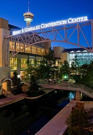 The exterior of the Henry B. Gonzalez Convention Center with a prominent tower and a bridge over a water feature. - Stunning 3 BR Home Near DT Alamodome - Riverwalk (San Antonio)